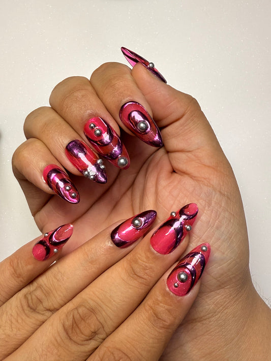 Hand with pink and purple nail art on a plain background pink chrome nail set abstract nail set
