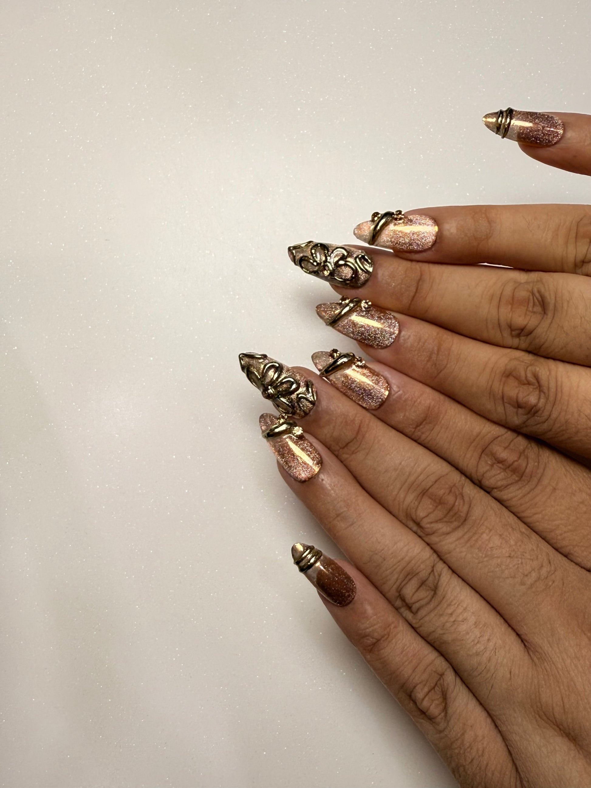 Nails with decorative gold and bronze tips on a plain background brown cat eye press on nail set  3D nail set chrome nail set