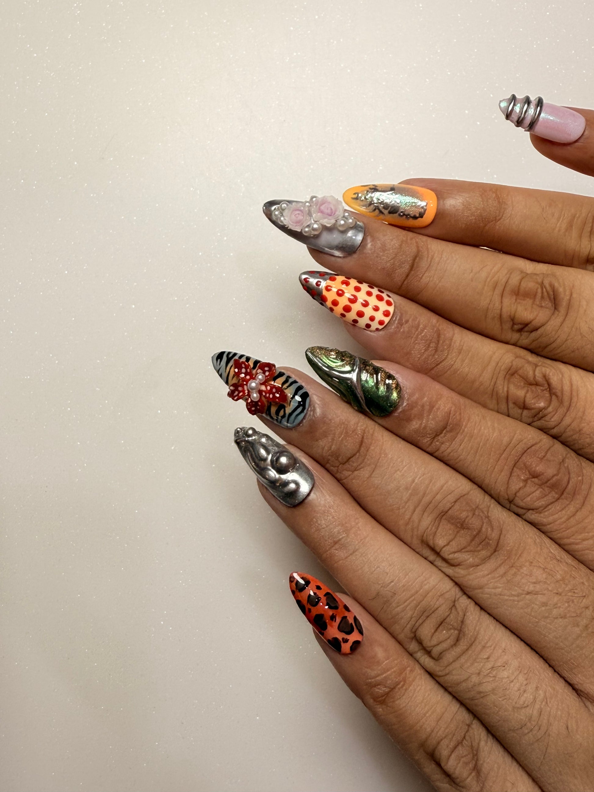 Close-up of hands with intricately designed nails on a light background nail art luxury press-on nail set chrome 3D flower nail set, pearl nails